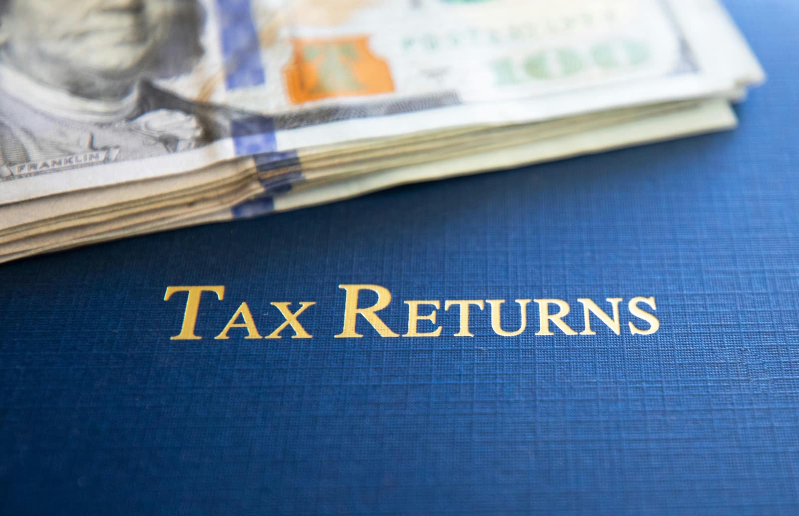 A tax-returns folder beside a cash reserve